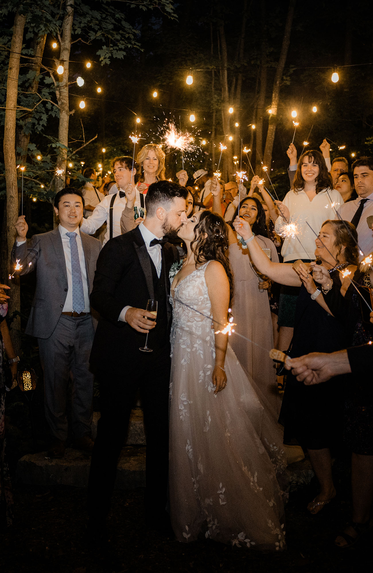 bride and groom kissing surrounded by sparklers